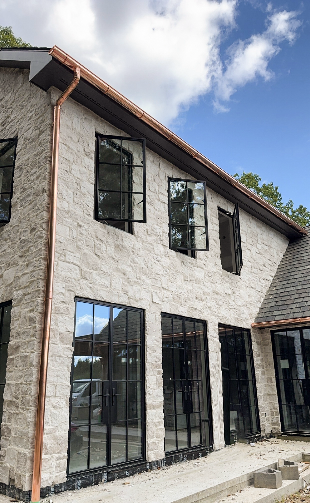 Custom Stone Farmhouse with Black Badge Steel Windows & Doors